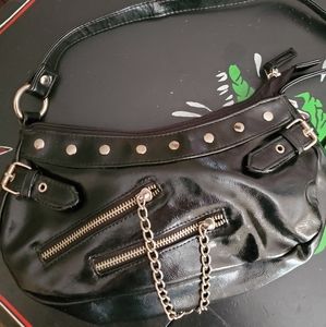 Patent leather handbag with studs, chains, zippers